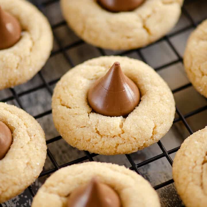 peanut butter blossom cookies on black cooling rack