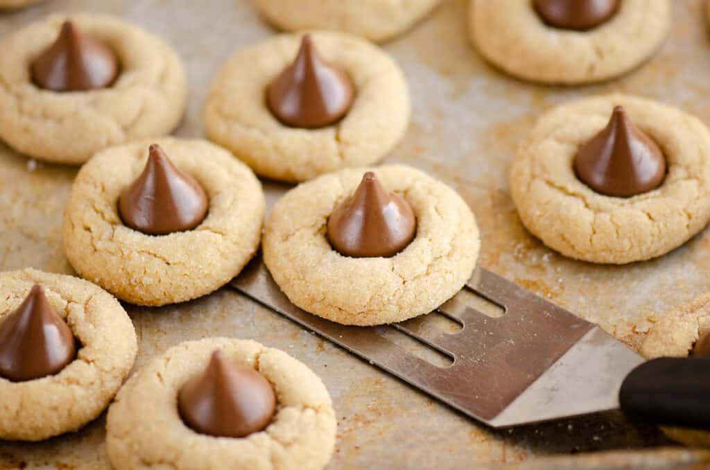 peanut butter blossom cookies removed from cookie sheet with spatula