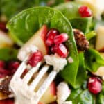 spinach pomegranate, feta and apple salad on fork