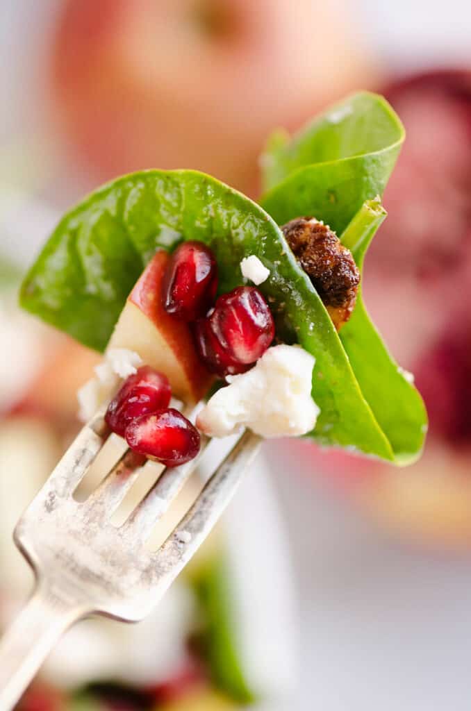 spinach pomegranate and feta salad on fork