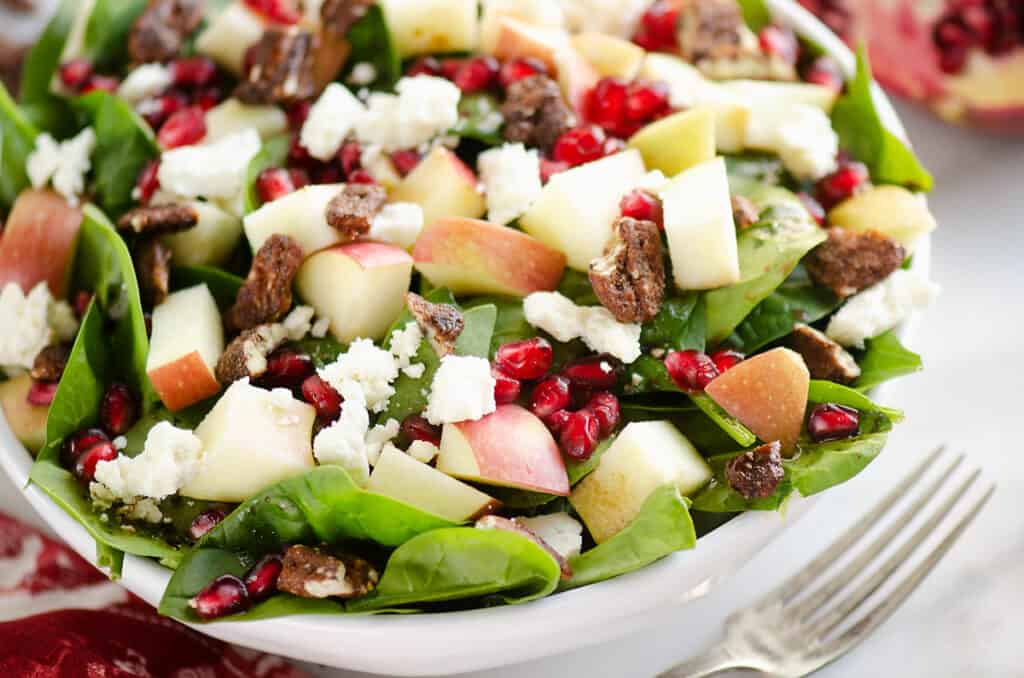 spinach salad with pomegranates, apples, feta and candied pecans