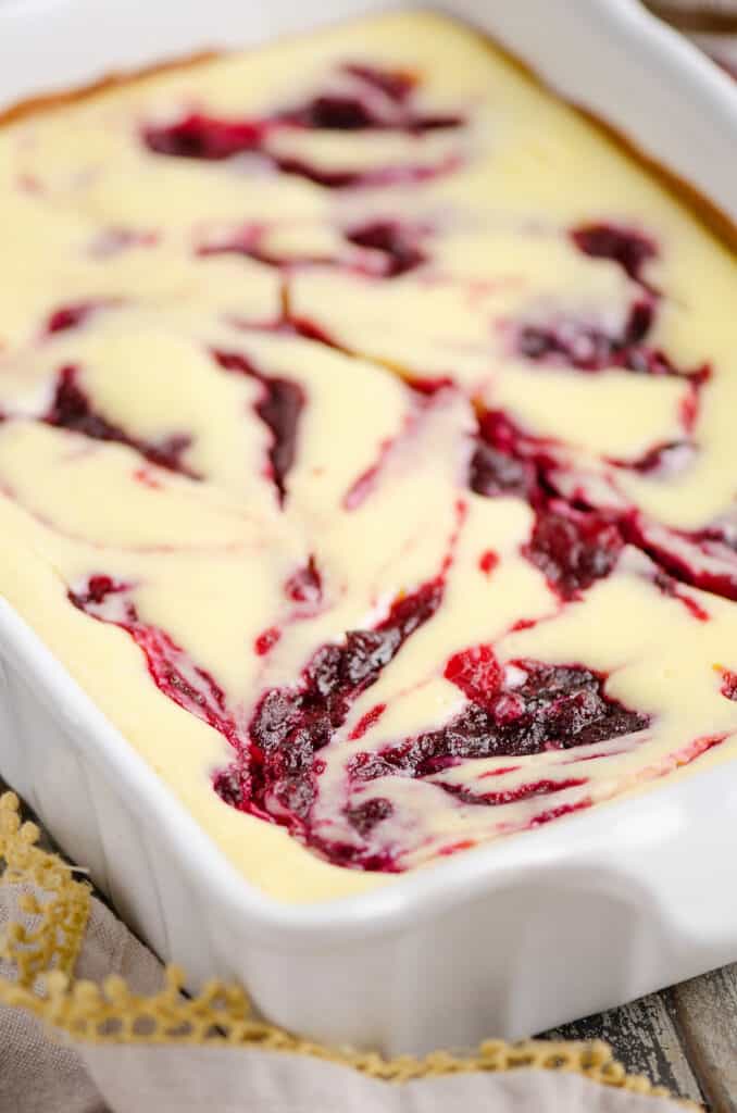 cranberry orange cheesecake swirl bars in pan