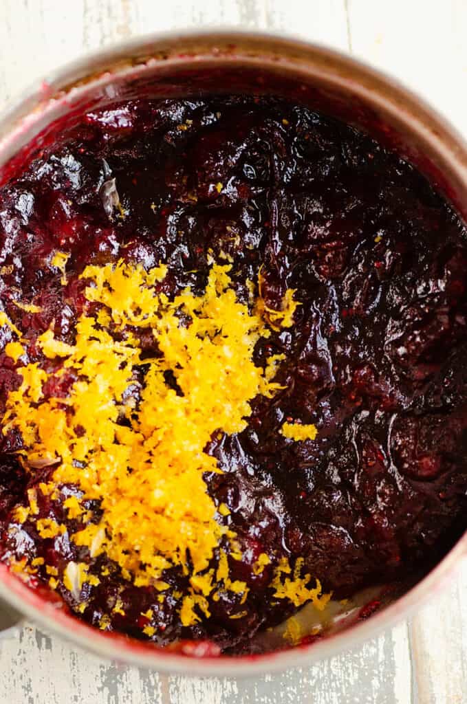 homemade cranberry sauce with orange zest in saucepan