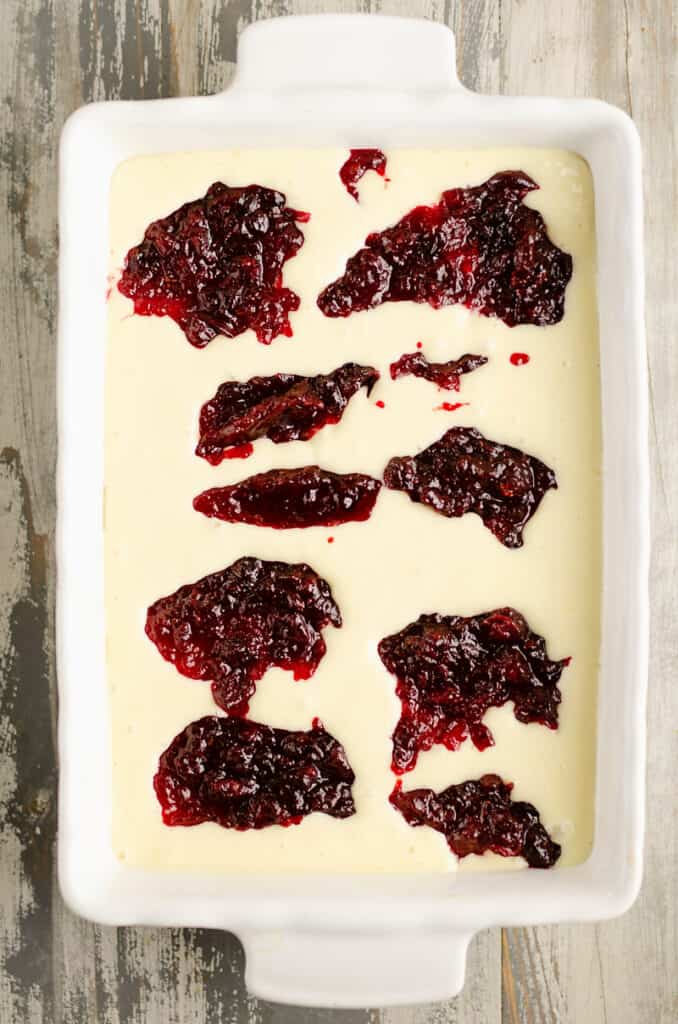 cheesecake bars topped with cranberry sauce