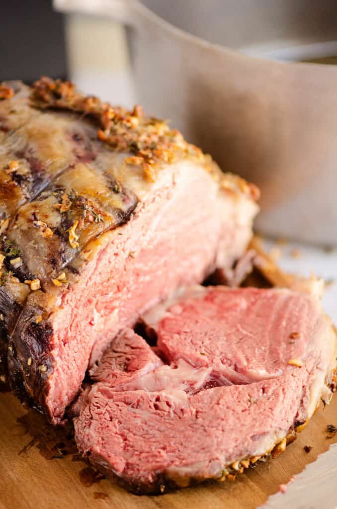 garlic butter prime rib sliced on cutting board