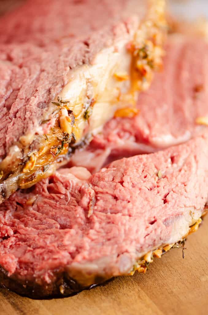 slices of garlic butter prime rib on cutting board