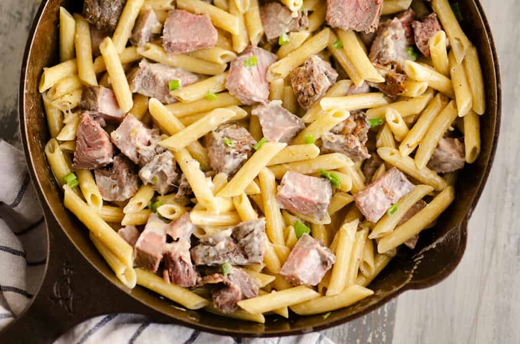 leftover prime rib and penne pasta in cast iron skillet