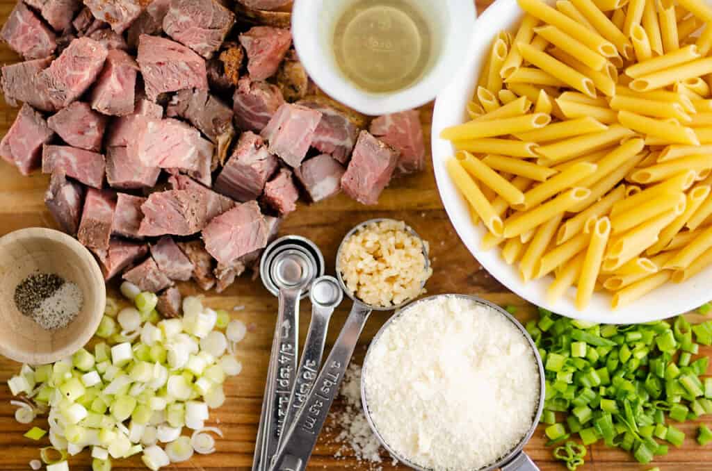 leftover prime rib and penne pasta ingredients on cutting board