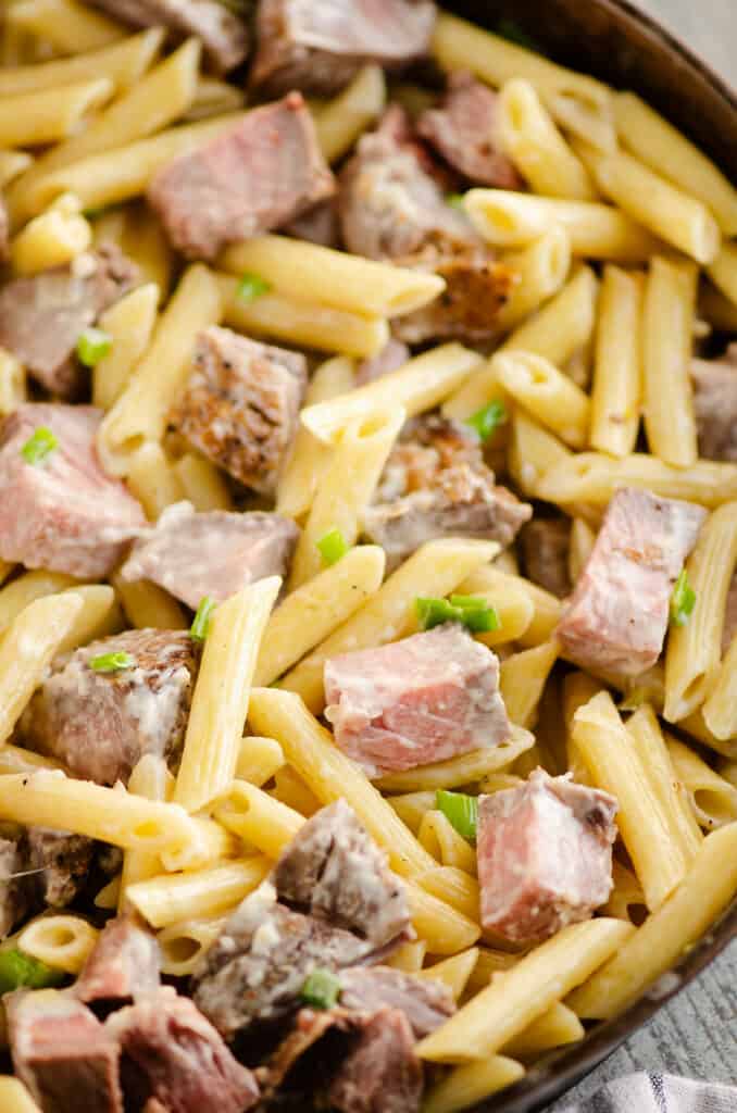 creamy leftover prime rib and penne pasta in skillet