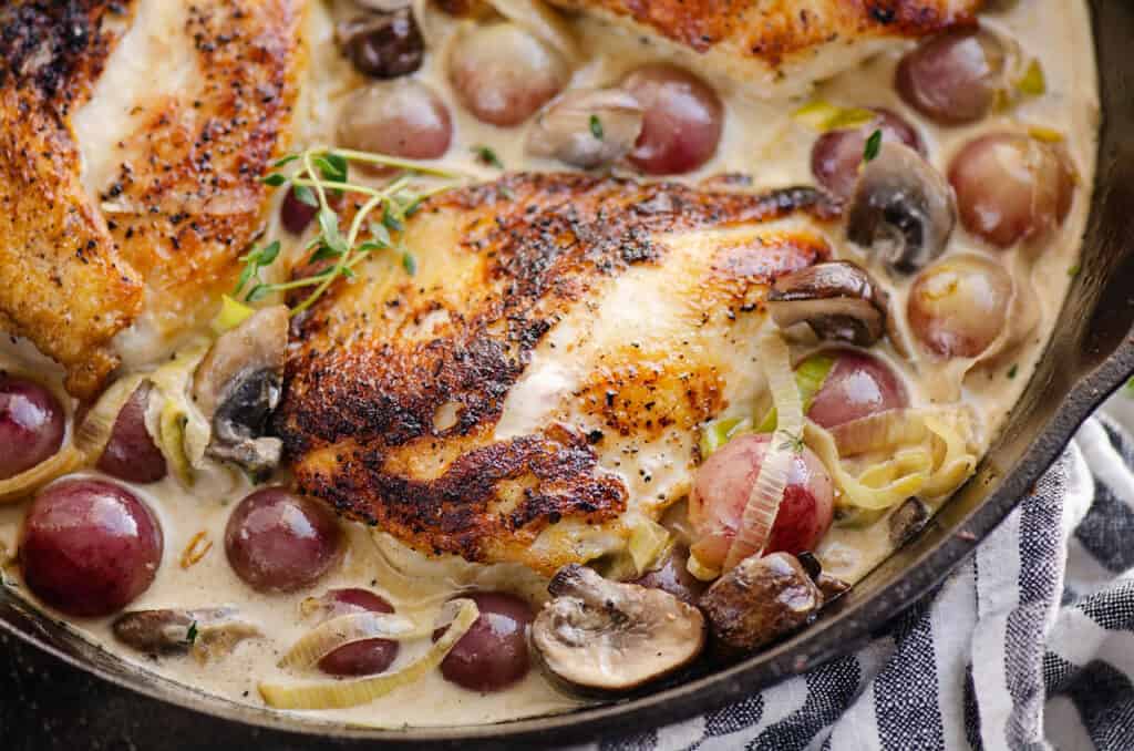 chicken and grapes in skillet with cream sauce