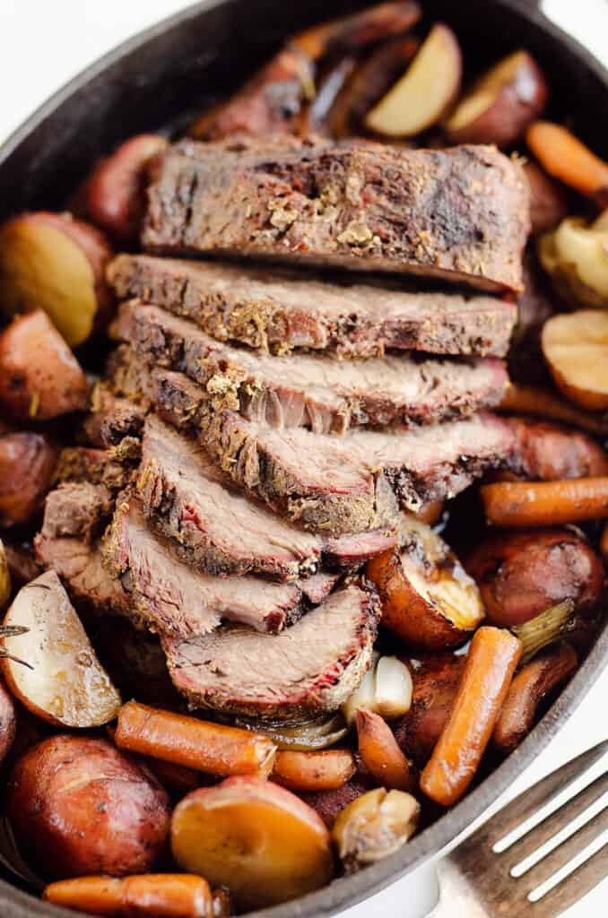 sliced pot roast over roasted vegetables