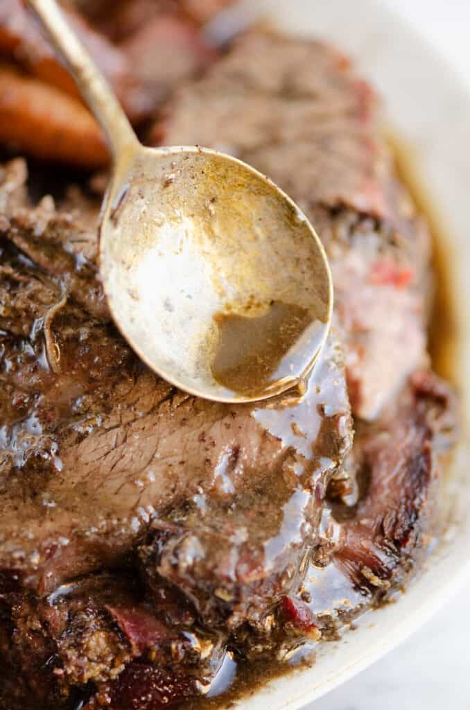 red wine sauce poured over smoked pot roast