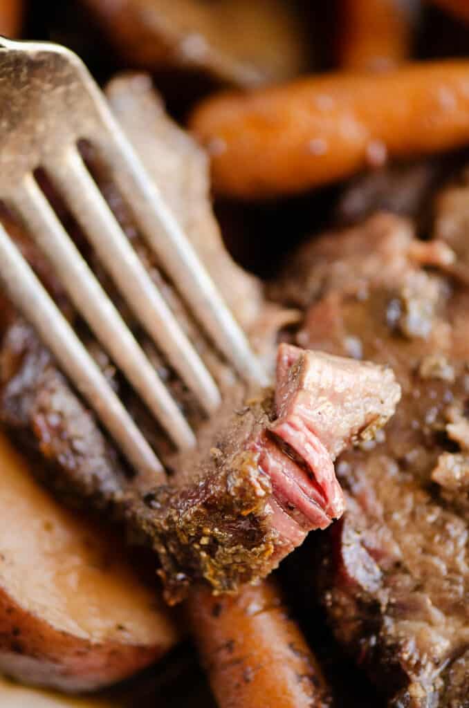 piece of smoked pot roast on fork with vegetables