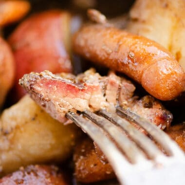 piece of pot roast with smoke ring on fork over vegetables