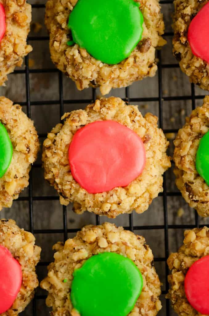 walnut thumbprint cookies with frosting on table