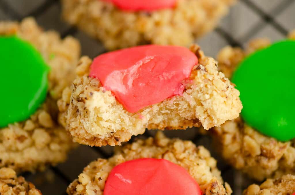 walnut thumbprint cookie with frosting with bite out of it