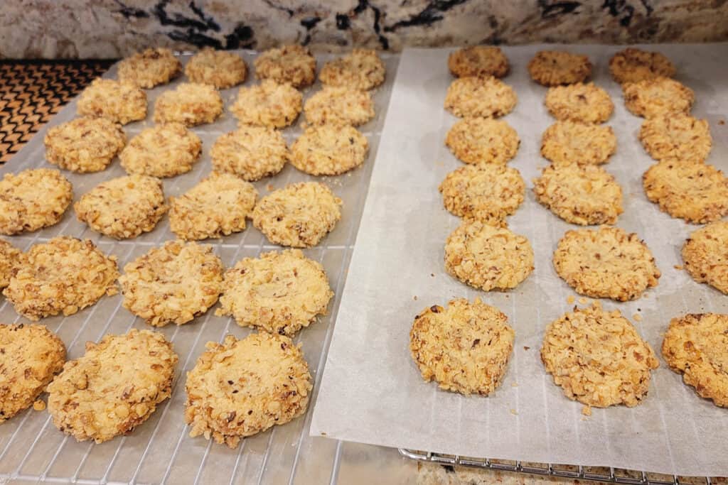 walnut thumbprint cookies on lined cooling racks