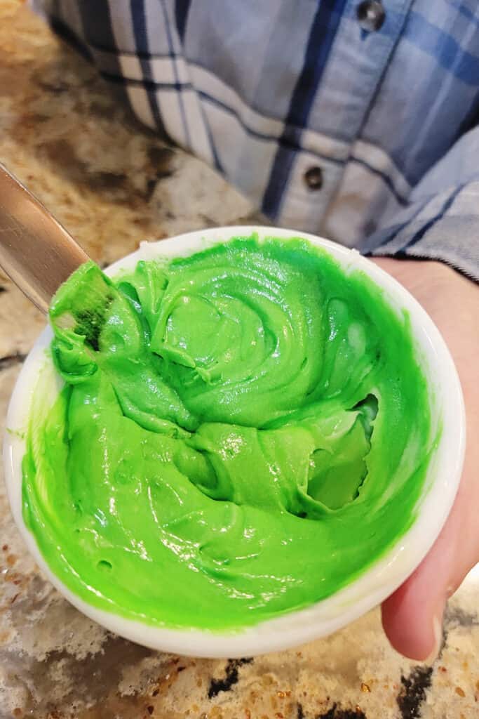 green icing in white bowl