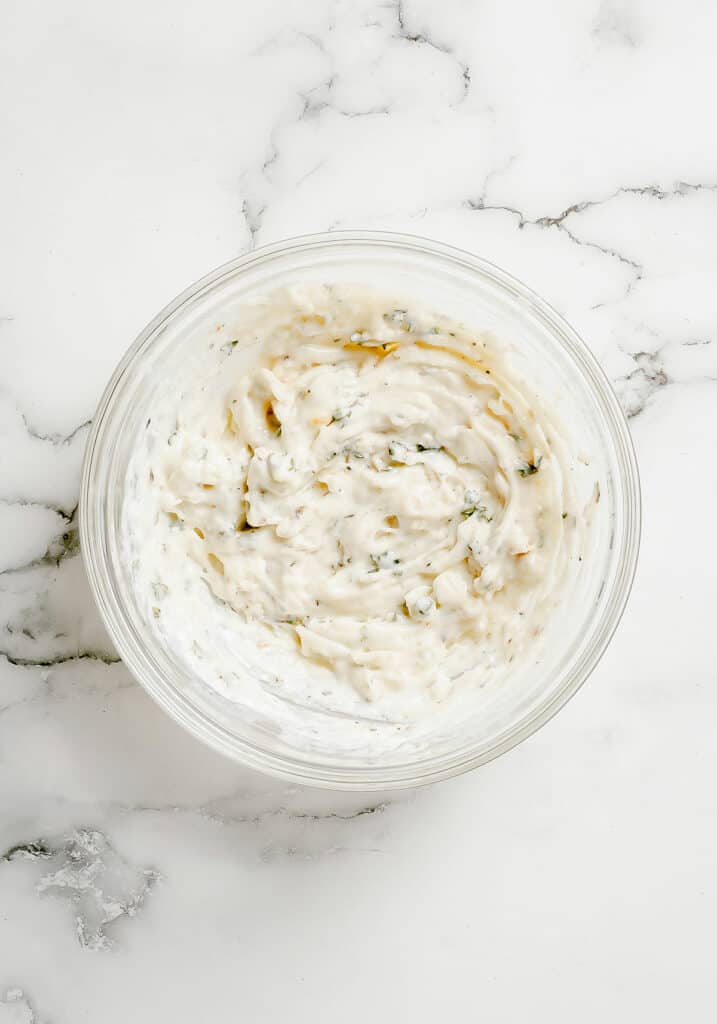 whipped herb goat cheese in glass bowl