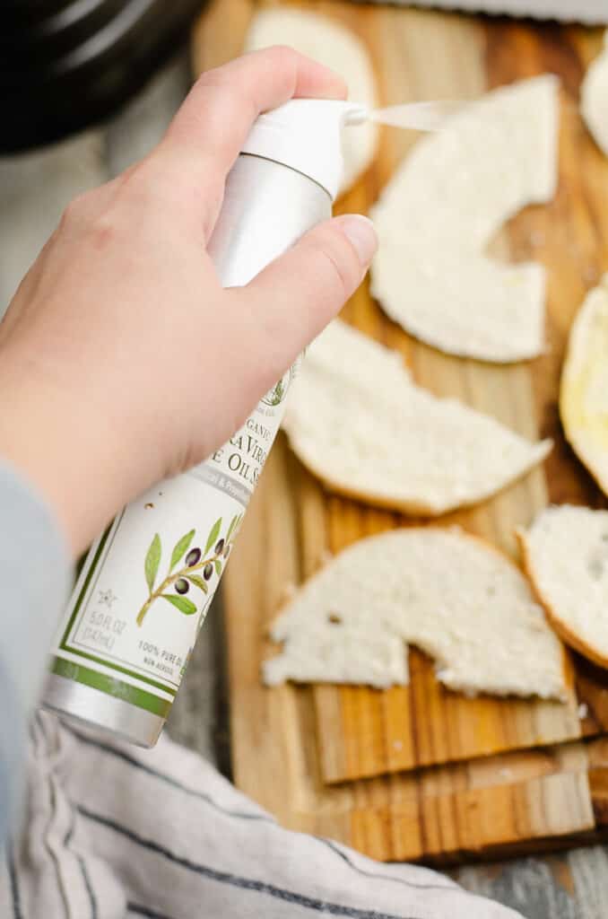 olive oil spray can spritzing bagel chips
