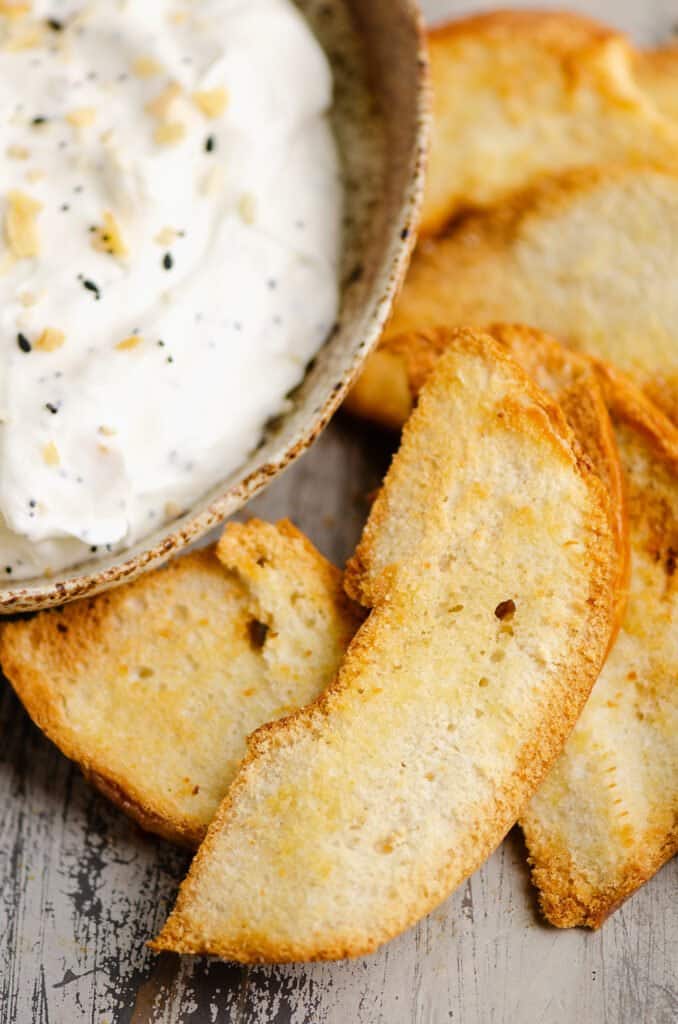 bagel chips with bagel dip in ceramic bowl