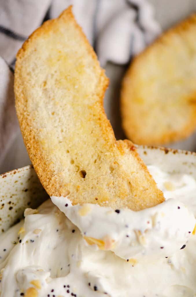 bagel chip dipped in sour cream dip