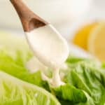 greek yogurt caesar dressing on wooden spoon