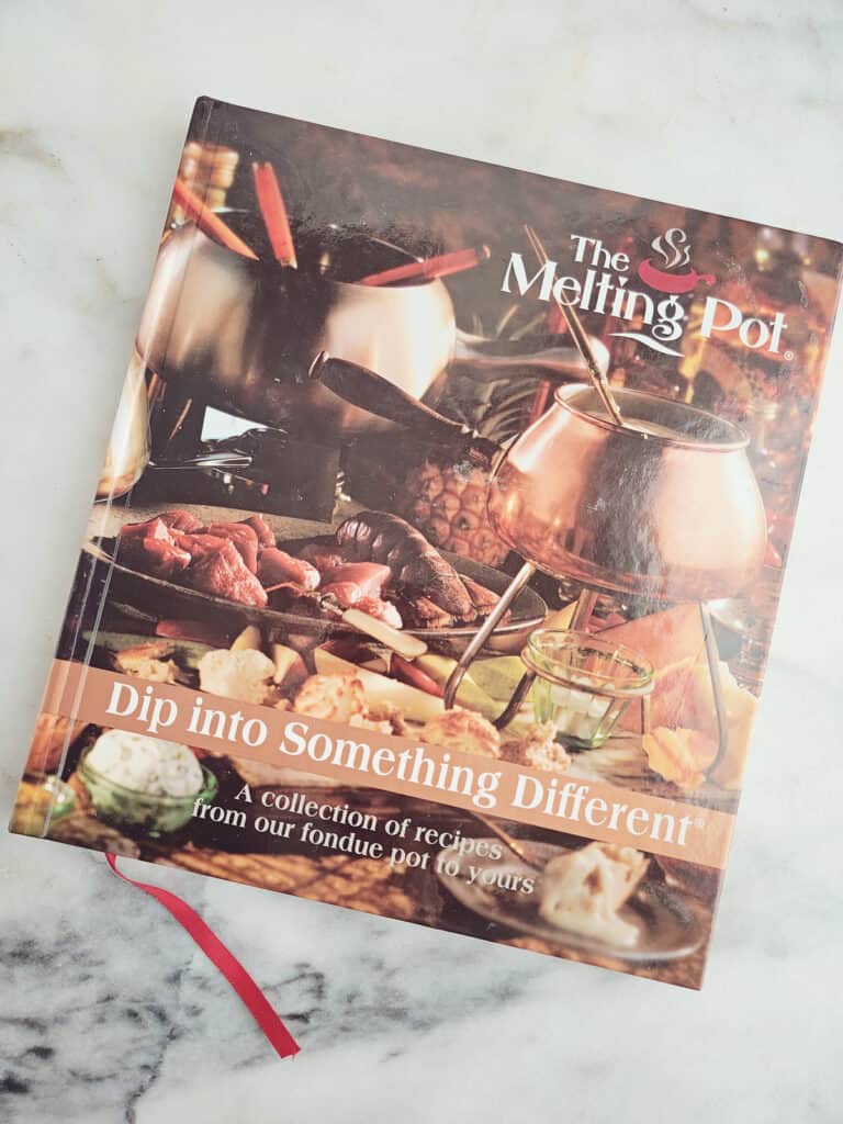 The Melting Pot cookbook on counter