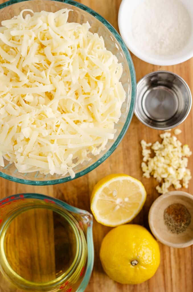 swiss cheese fondue ingredients on cutting board