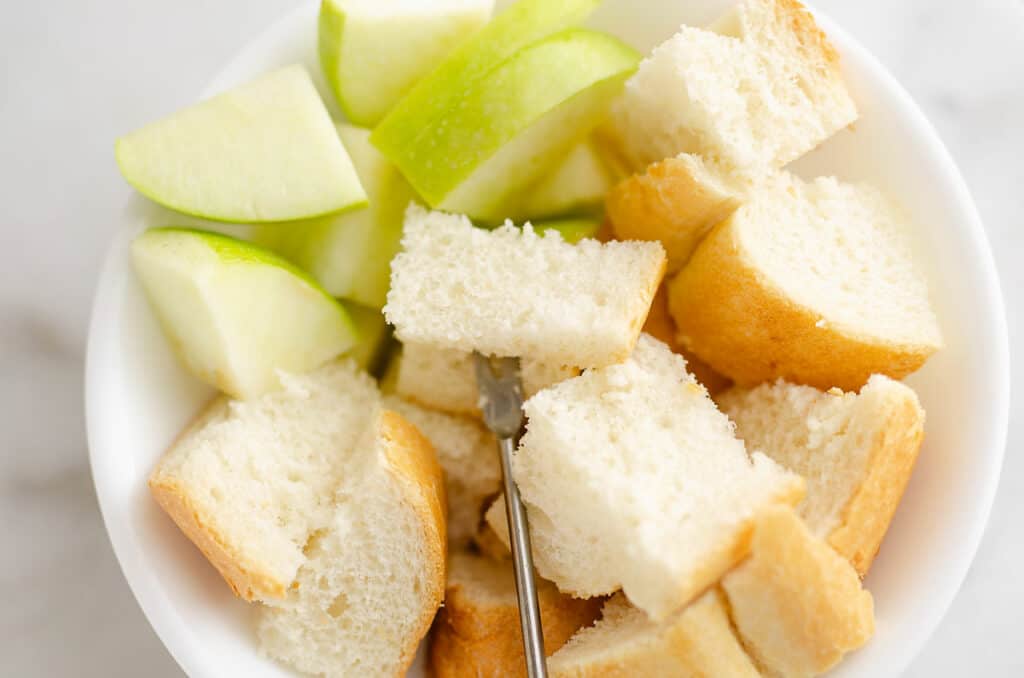 French bread and apples in bowl for fondue