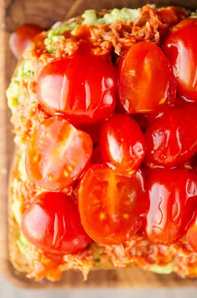 Buffalo Tuna Avocado Toast topped with cherry tomatoes