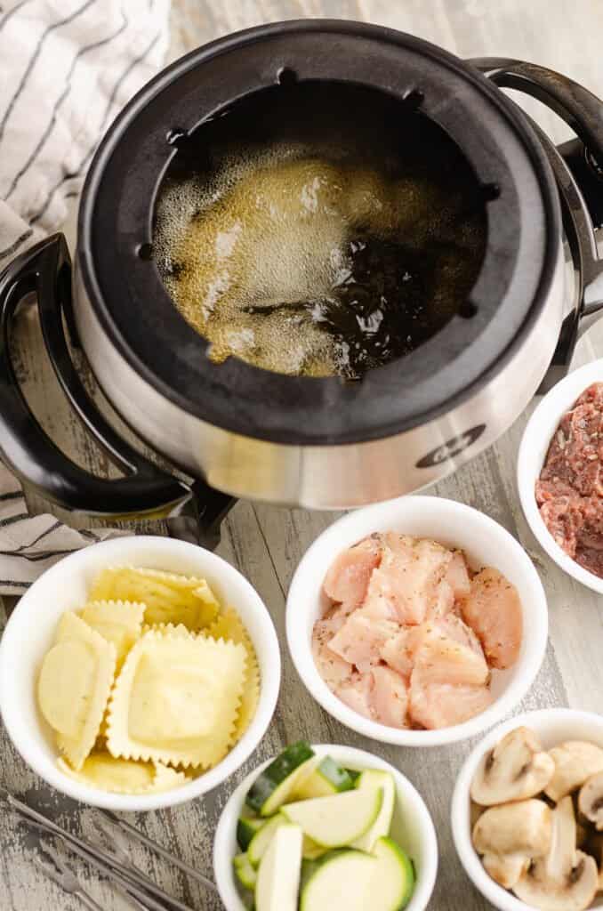 broth fondue pot with dippers in bowls