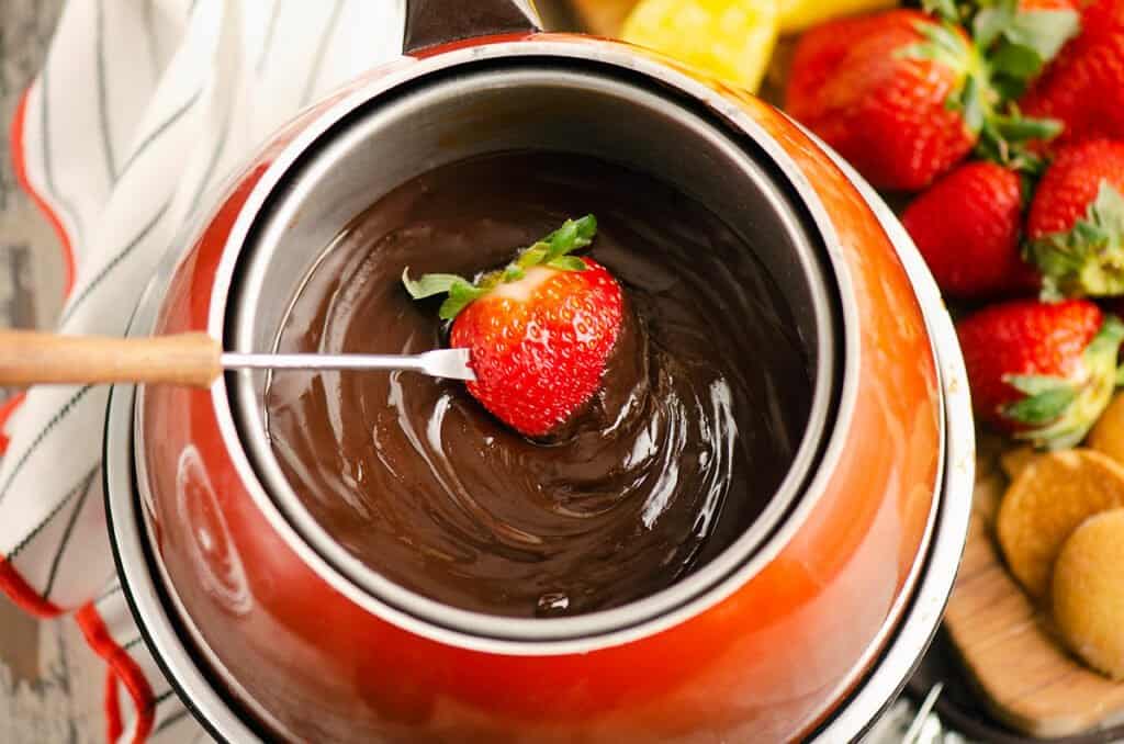 chocolate fondue pot dipped with a strawberry