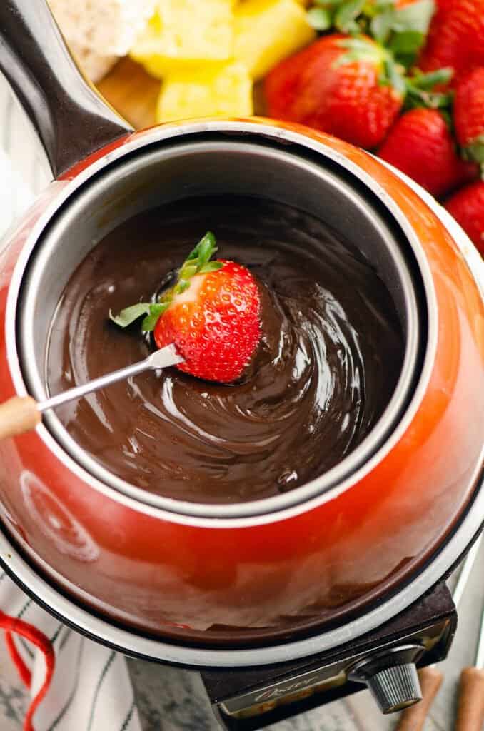 strawberry dipped in chocolate fondue pot