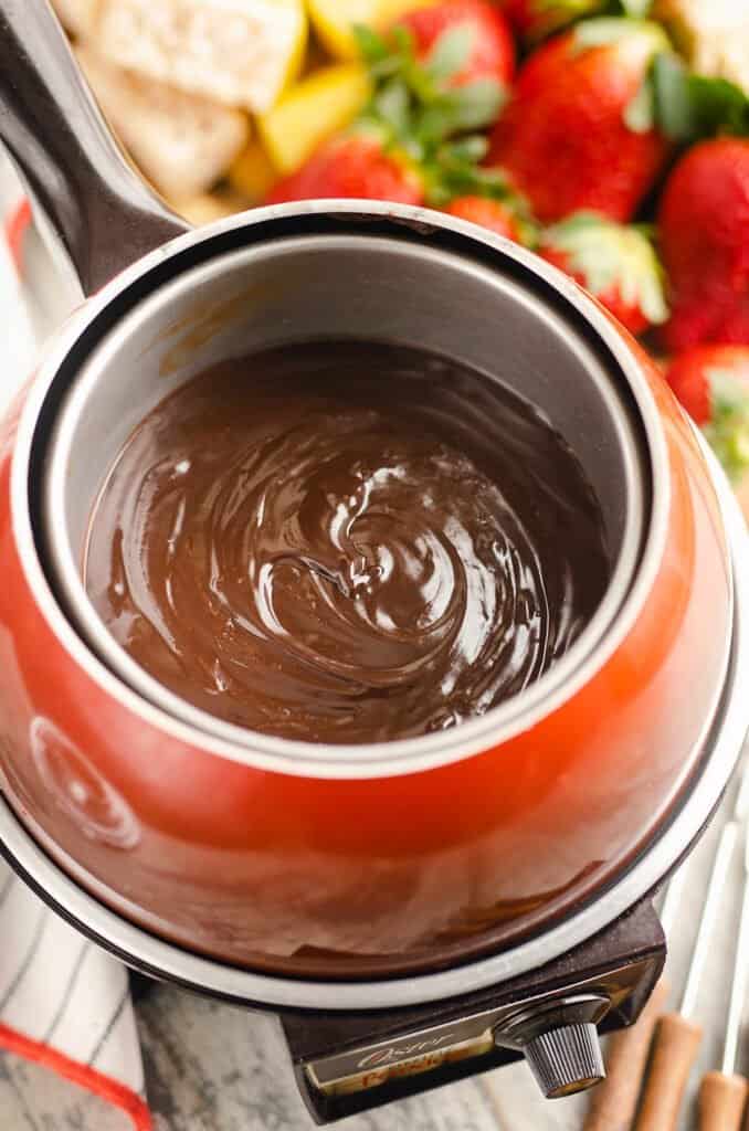 red fondue pot with chocolate fondue