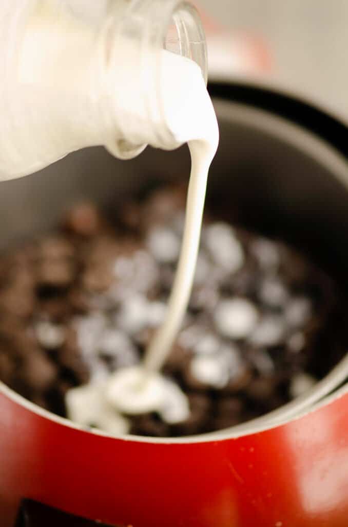 cream poured into pot of chocolate chips in fondue pot