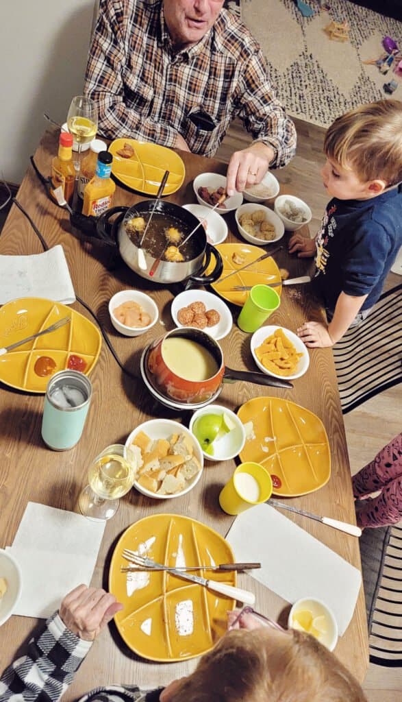 family dinner table with fondue spread