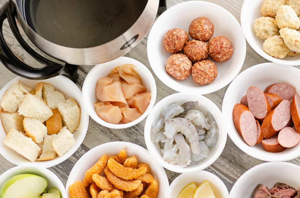 table full of fondue dippers in small bowls