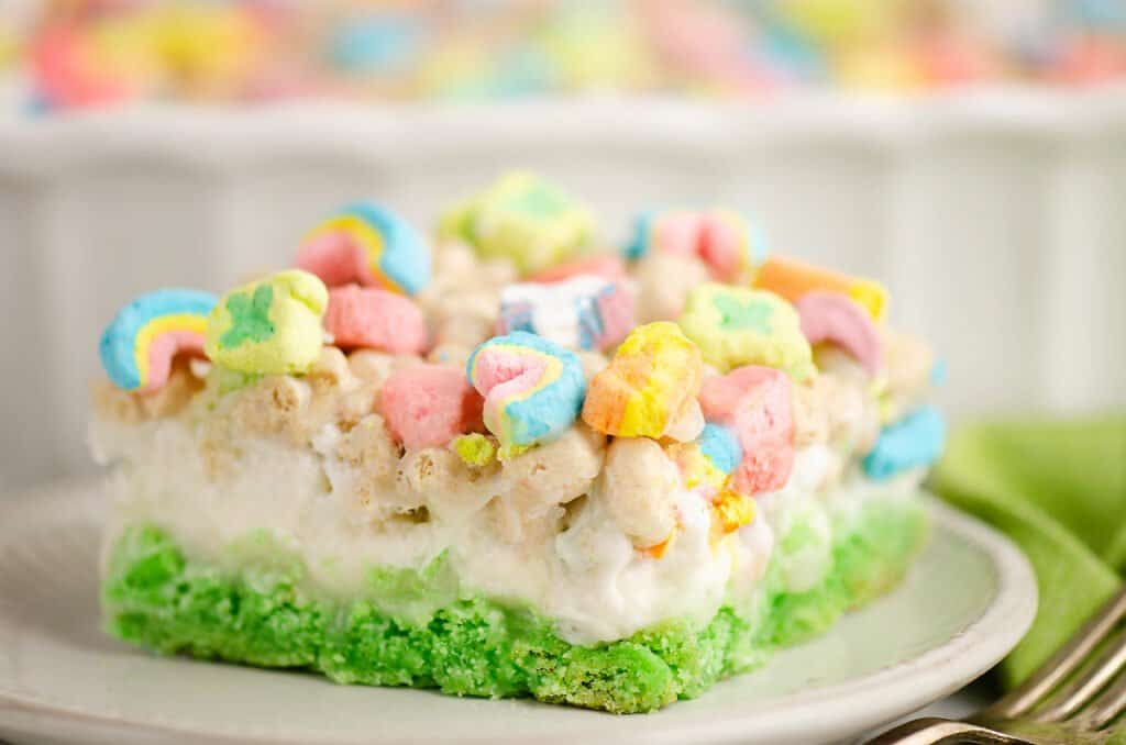 lucky charms cake bar on white plate with green napkin