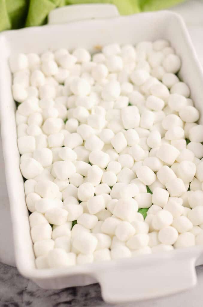 marshmallows over green cake in white pan