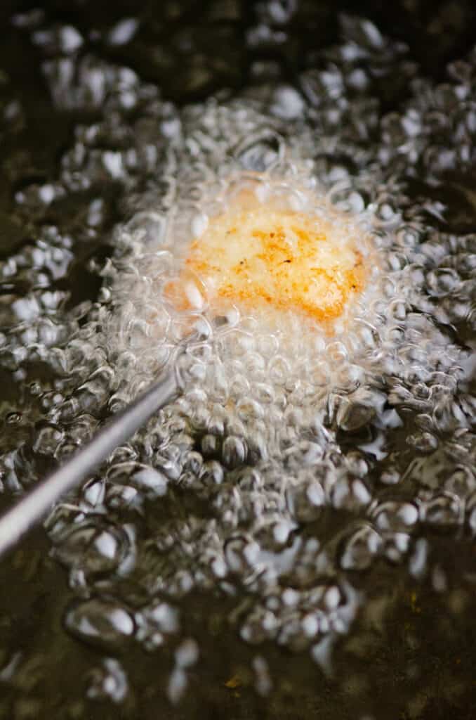 meat on fondue fork cooked in oil