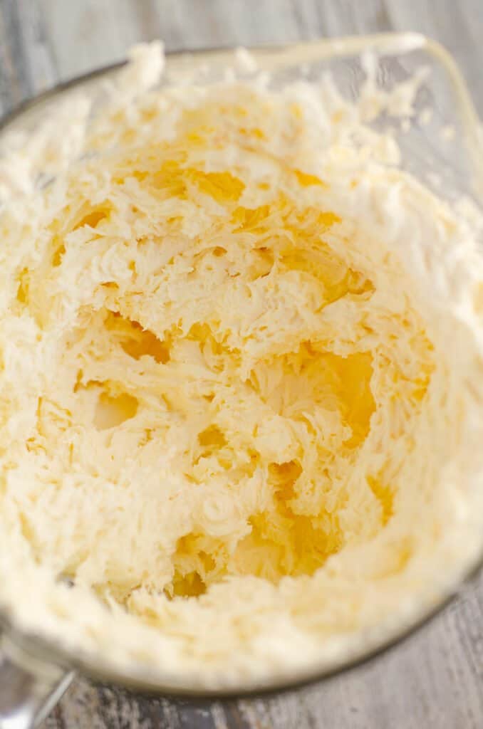 orange buttercream in glass bowl