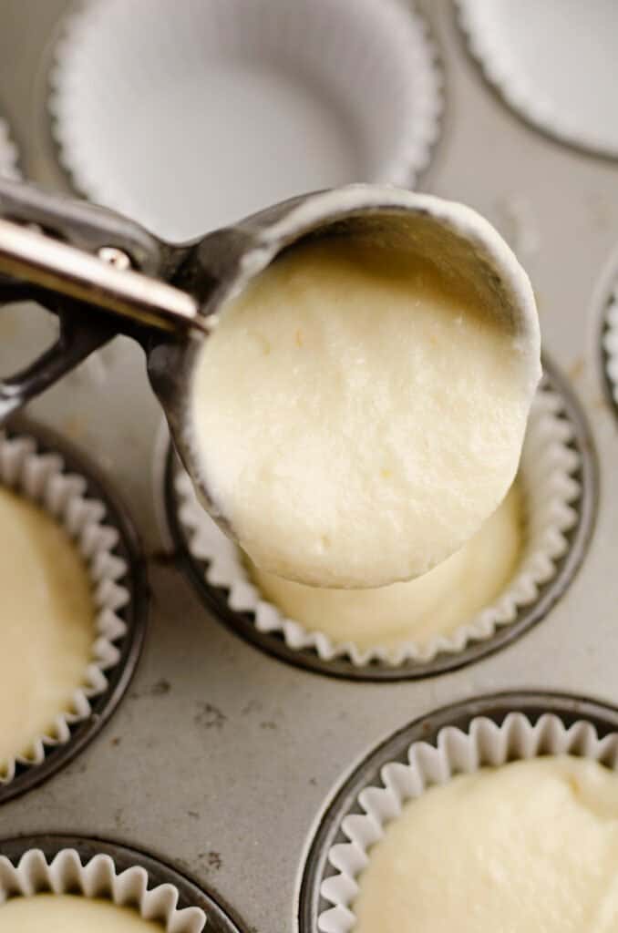 cupcake batter being scooped into liners