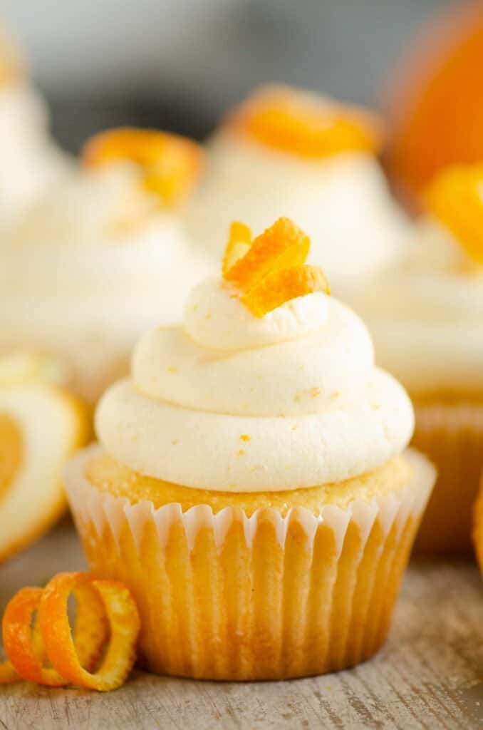 orange creamsicle cupcake topped with buttercream with orange peel
