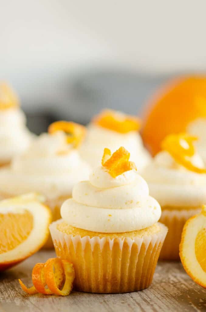 orange cupcakes on table with orange twists