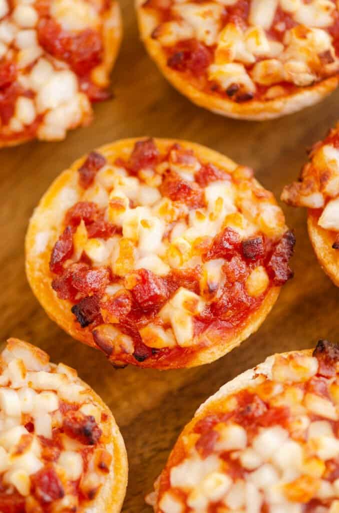 cooked bagel bites on cutting board