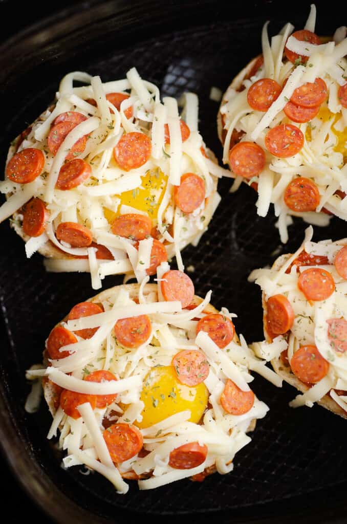 english muffin pepperoni and egg pizzas in Air Fryer basket