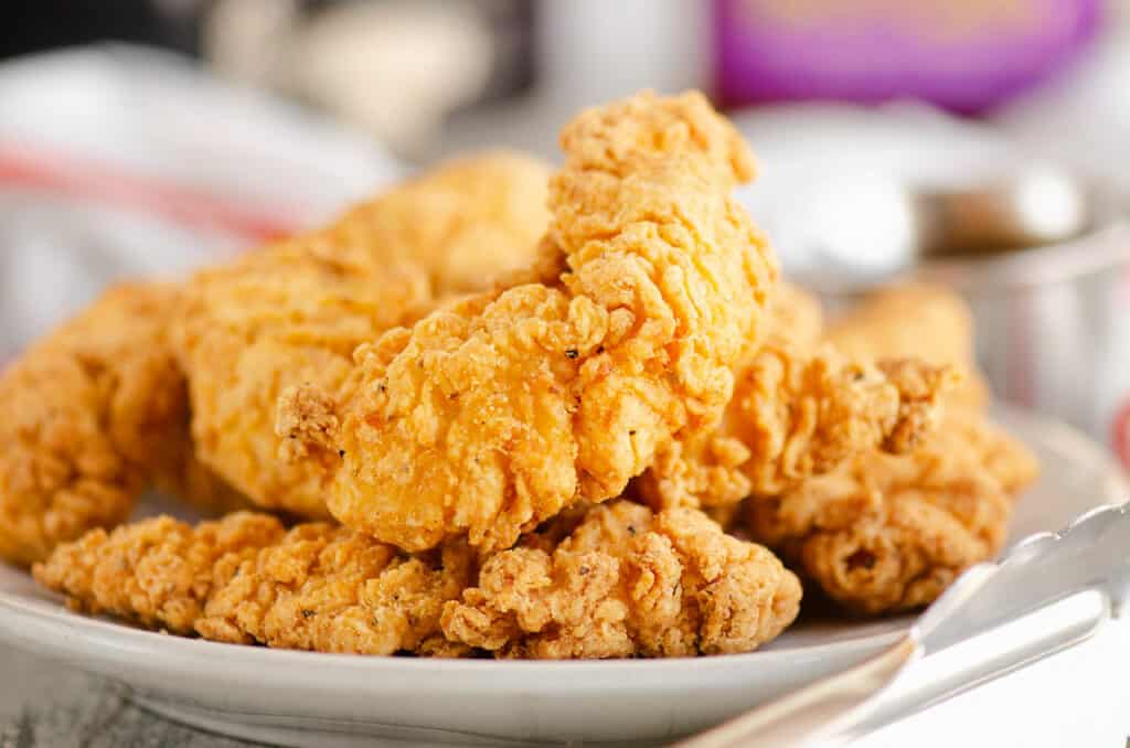 crispy chicken strips piled on plate