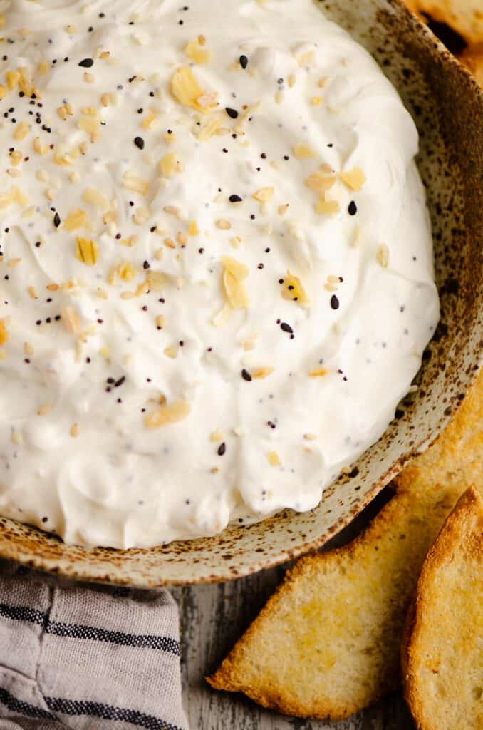 bowl of everything bagel dip with crackers and napkin