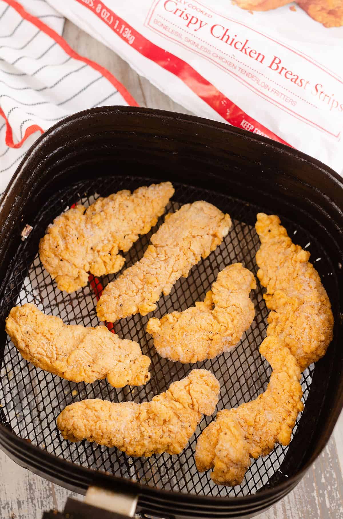 frozen chickens strips in Air Fryer basket